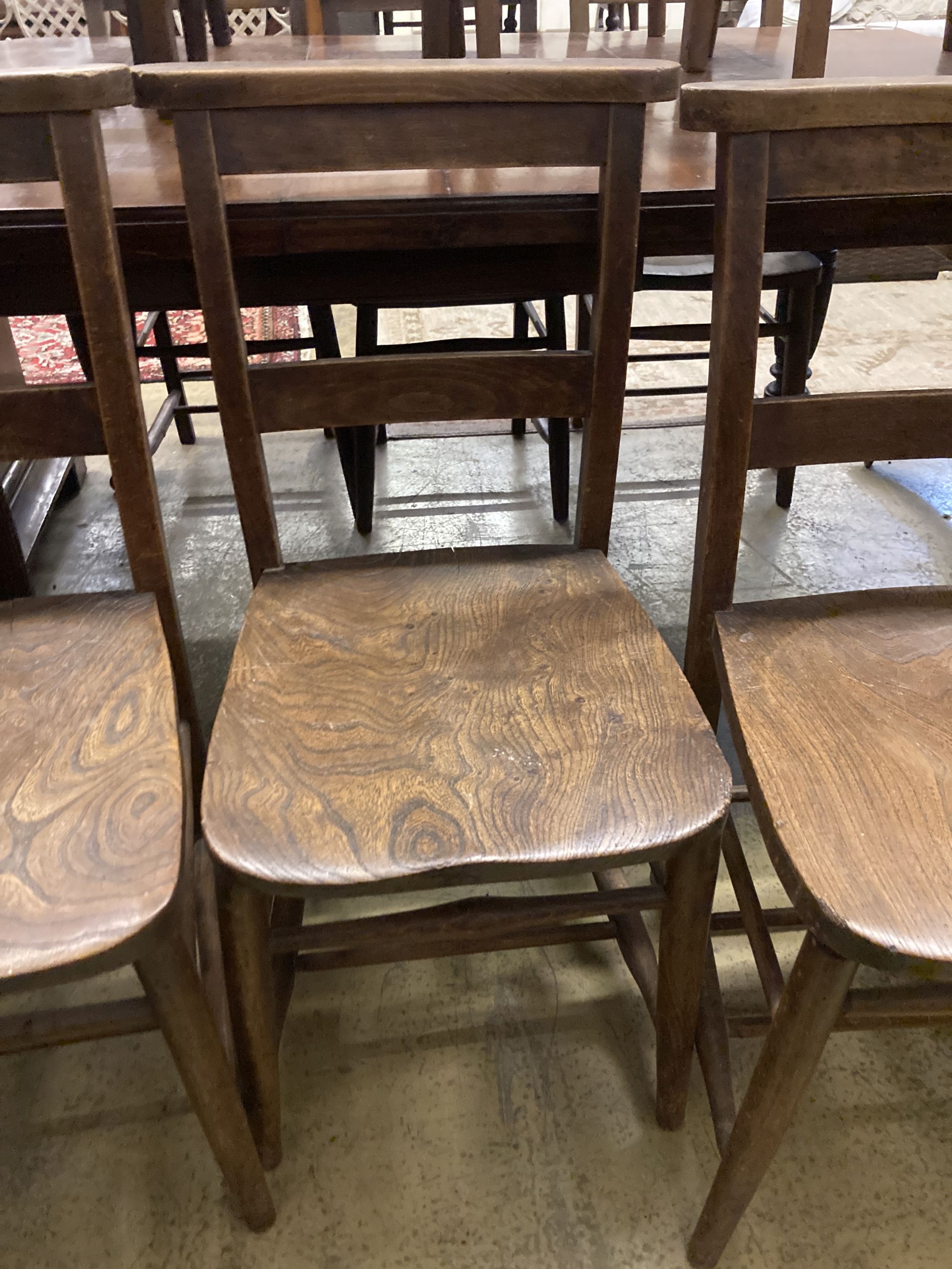 A set of four late Victorian elm and beech chapel chairs.